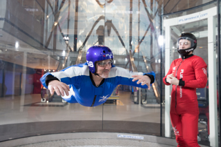 Man flying facing the camera with instructor closeup