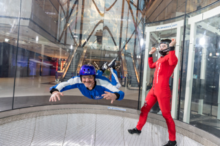 Man flying facing the camera with instructor 4